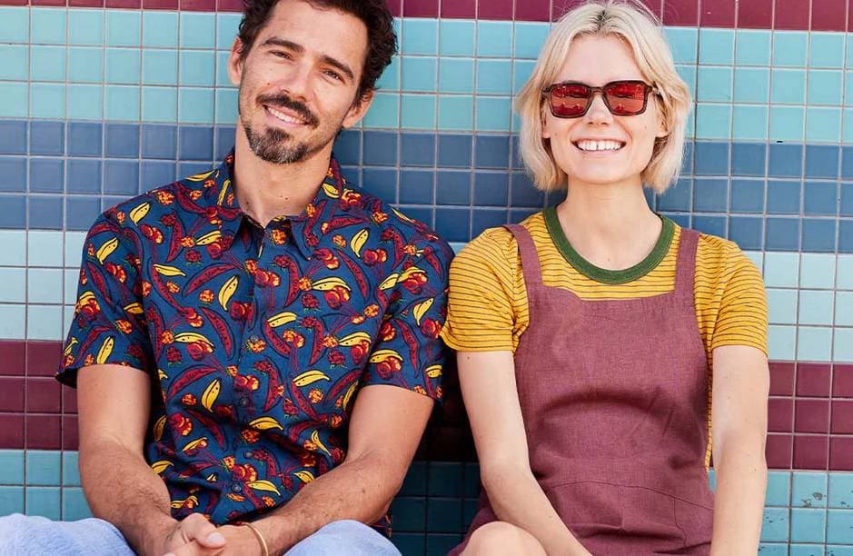 A brown-haired man and a blonde woman in color clothing from Toad&Co sit in front of a tiled wall.